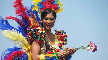 A Colombian woman dressed in colorful costume for a festival